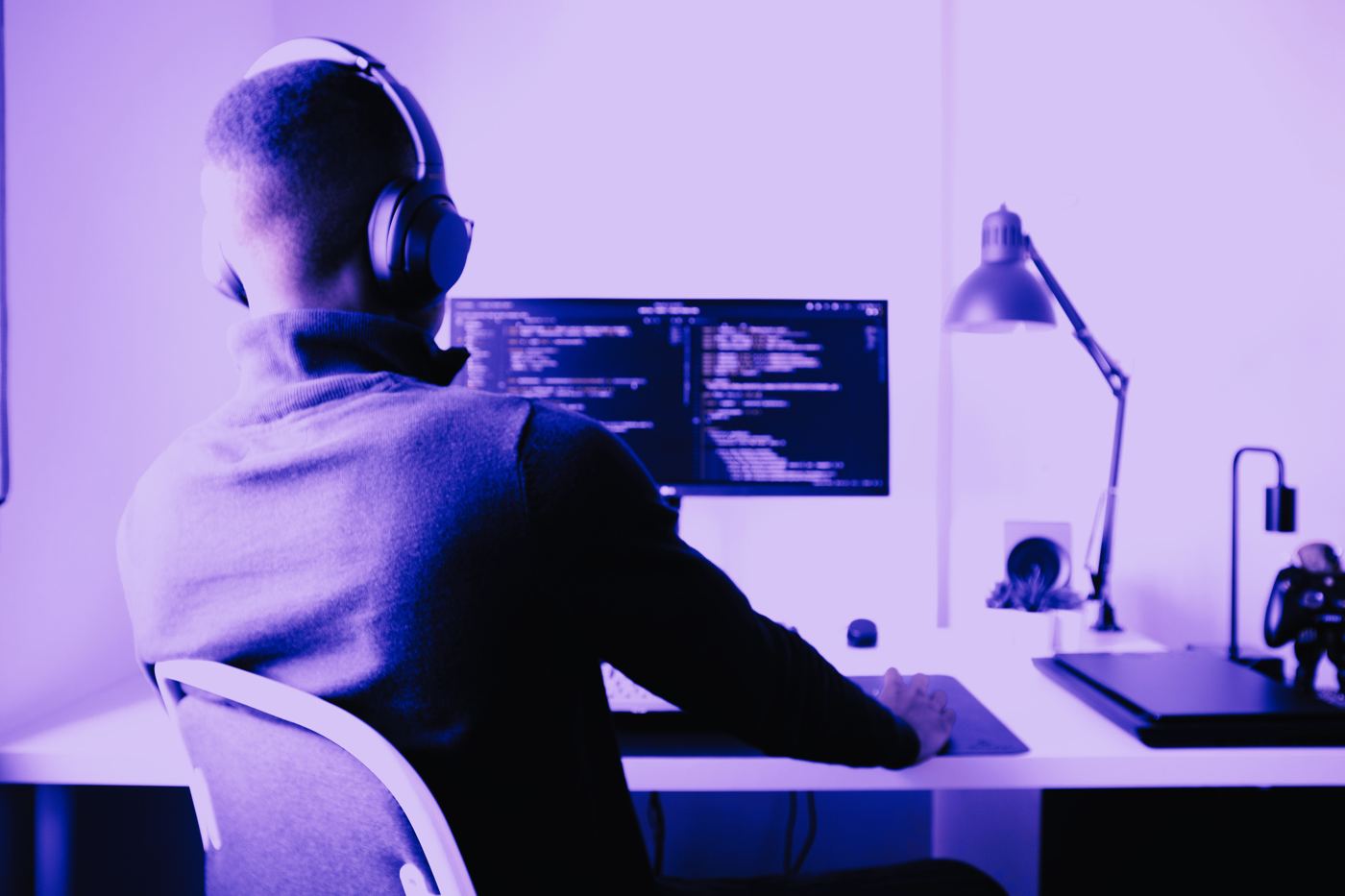 A developer at a desk with code on screen
